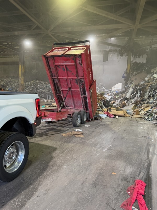 Loaded dump trailer full of mixed debris