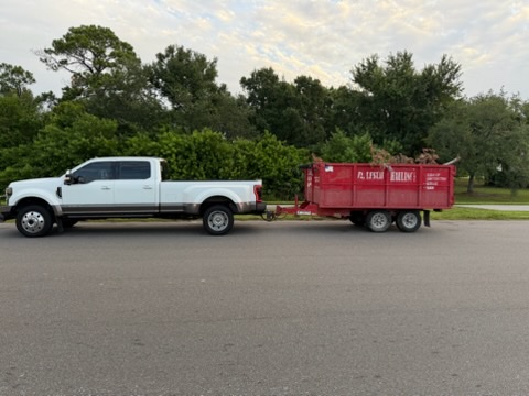 Dump trailer being towed for delivery