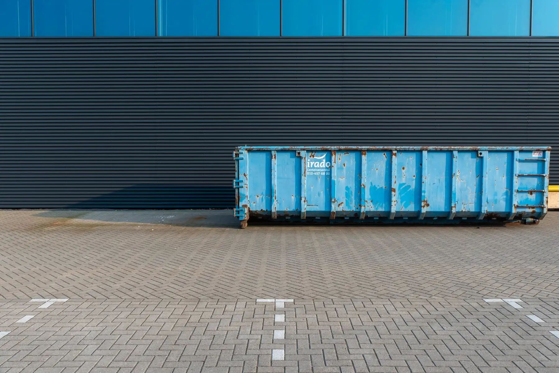 Dump trailer beside a commercial building