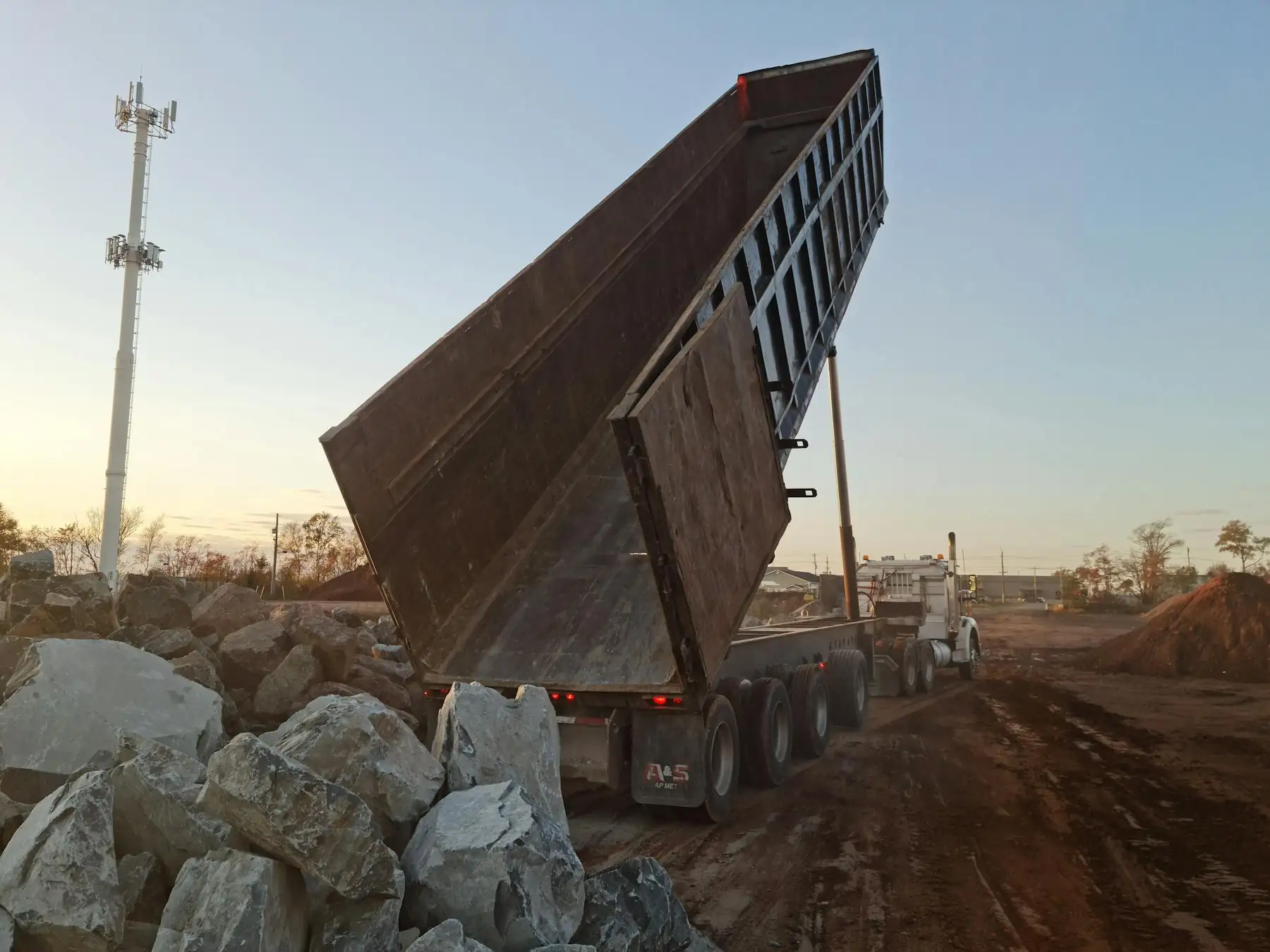 R. Leslie Hauling truck working at golden hour