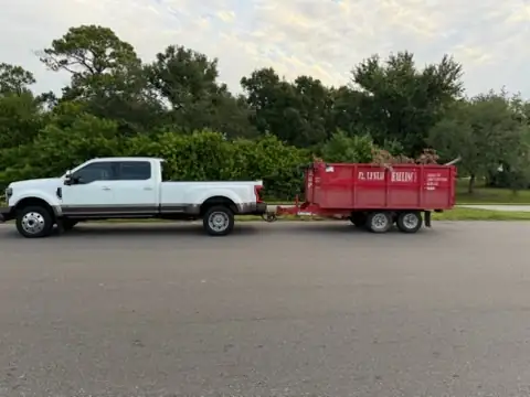 R. Leslie Hauling truck delivering a dump trailer