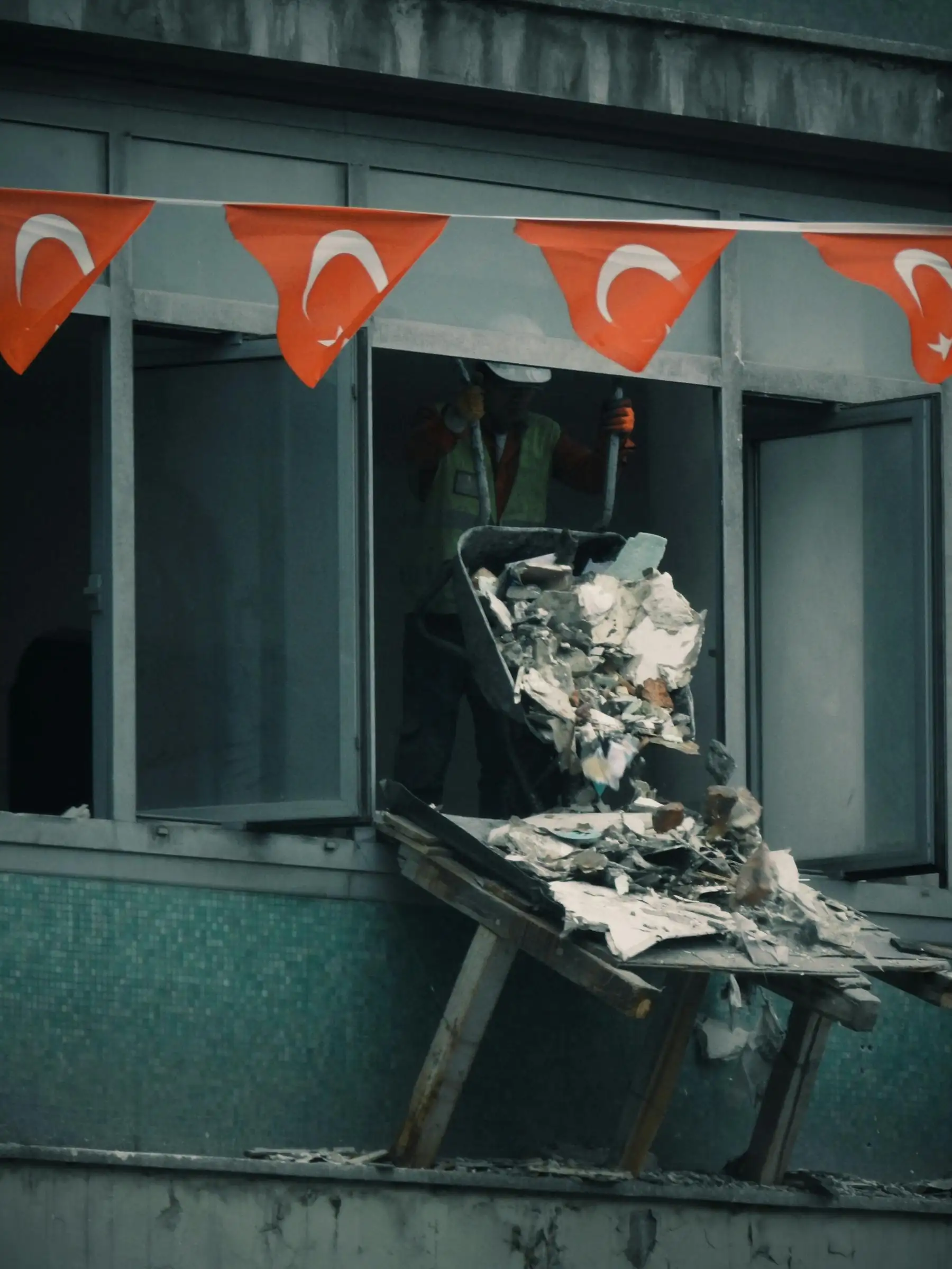 Roofing debris going down a chute into a container